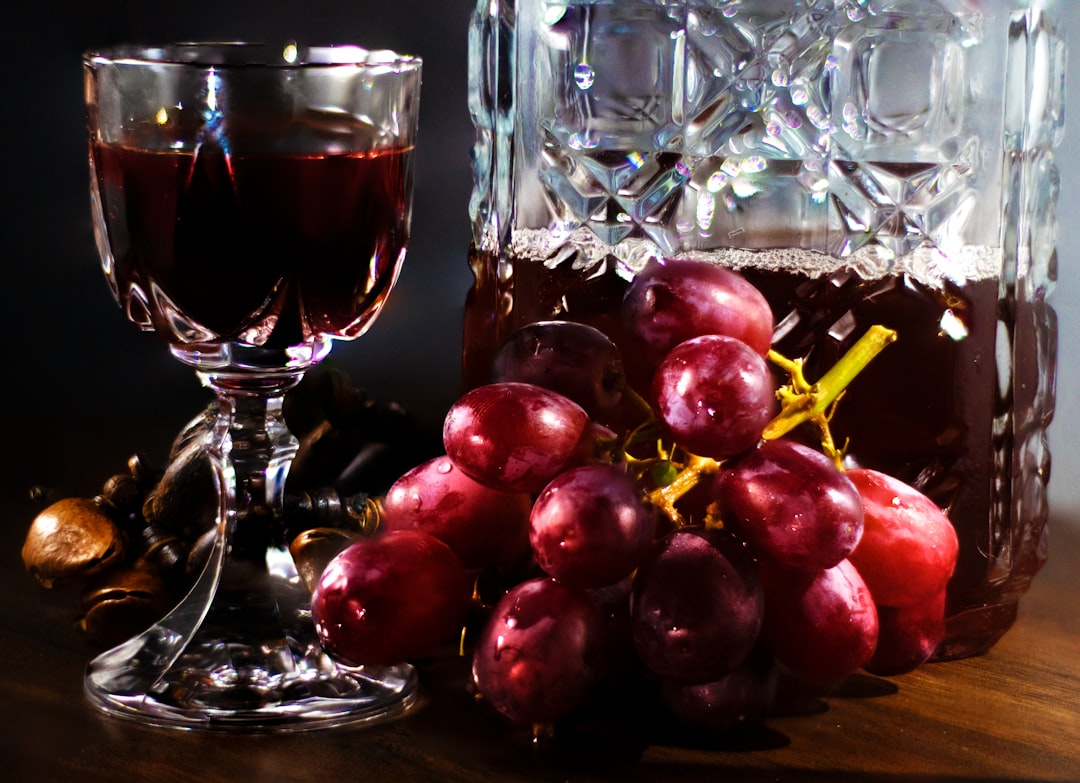 red round fruit beside clear wine glass