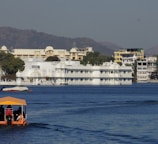 white and brown concrete building beside body of water during daytime