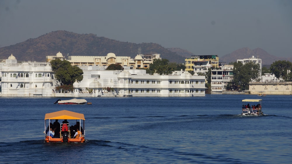 white and brown concrete building beside body of water during daytime