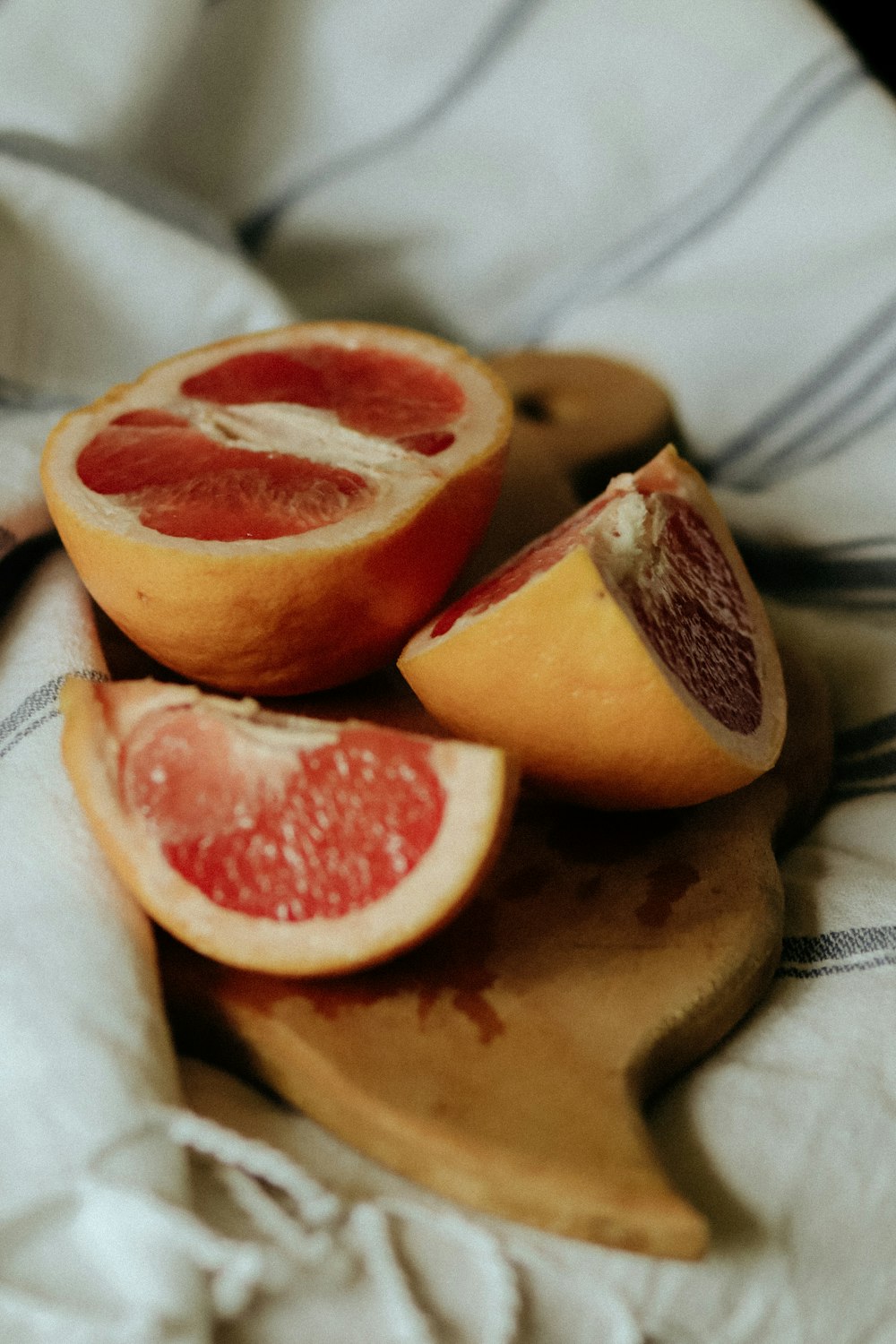 sliced orange fruit on white textile