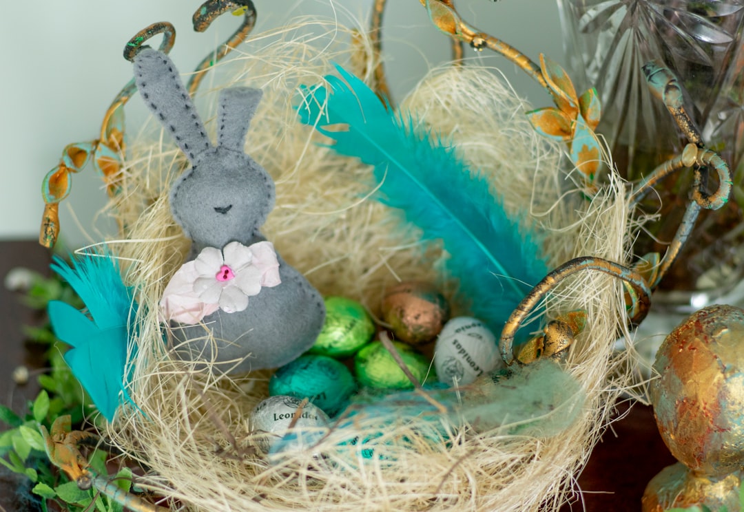 gray rabbit plush toy on brown nest