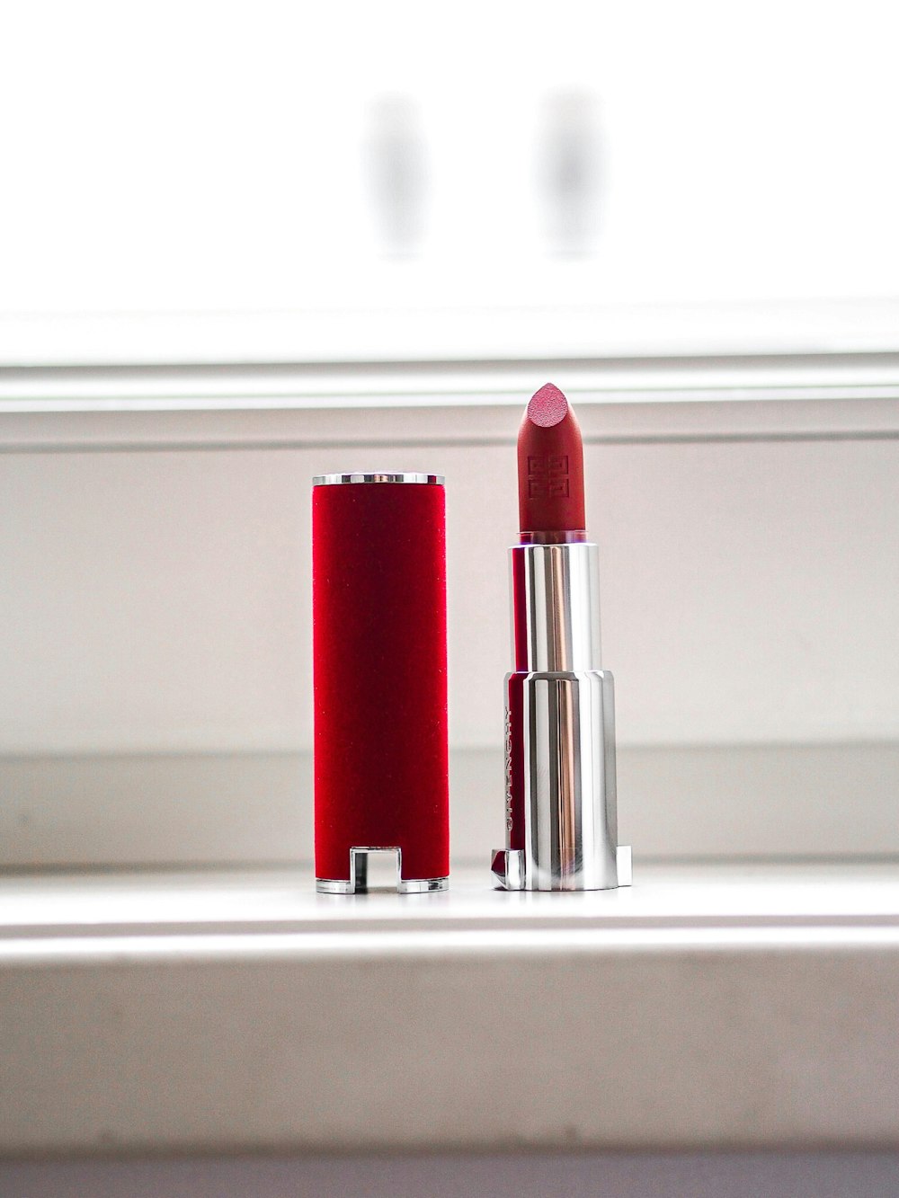 red lipstick on white table