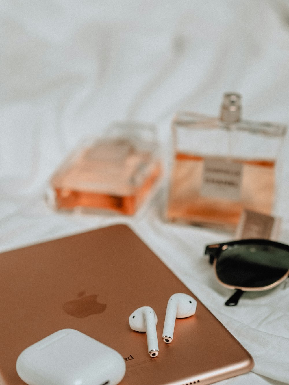 black sunglasses beside white apple earpods