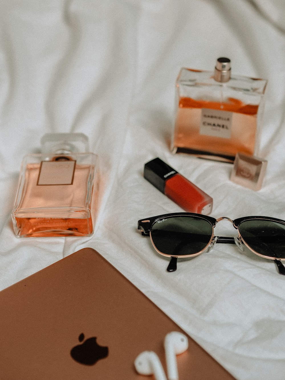 black framed sunglasses beside brown leather wallet