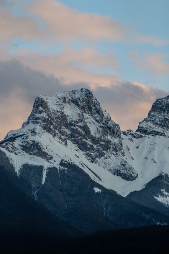 snow covered mountain under cloudy sky during daytime in The Three Sisters Canada