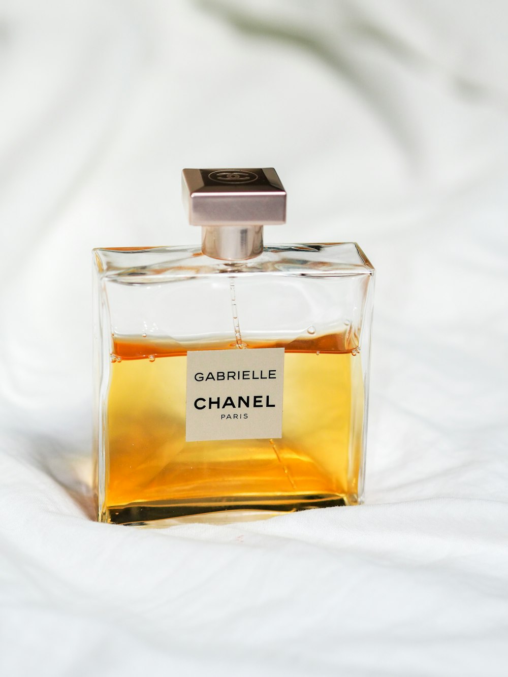 chanel perfume bottle on white textile