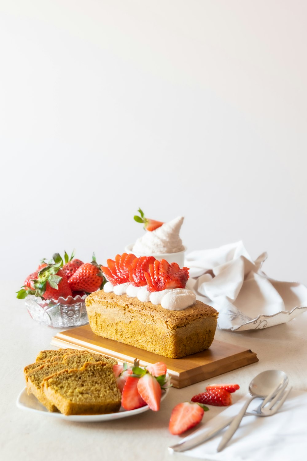 brown and white cake with strawberry on top