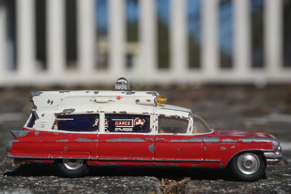 red and white vintage car on road during daytime