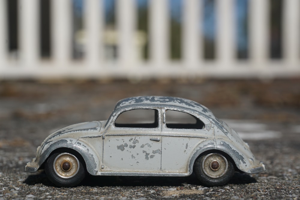 white volkswagen beetle parked on the street during daytime