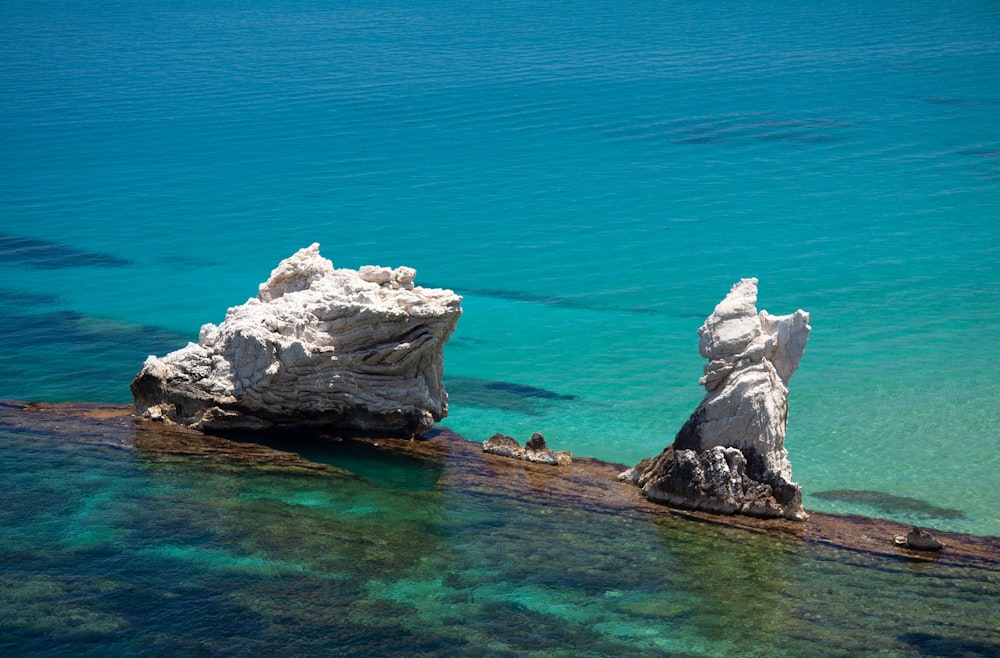 white rock formation on blue sea water during daytime