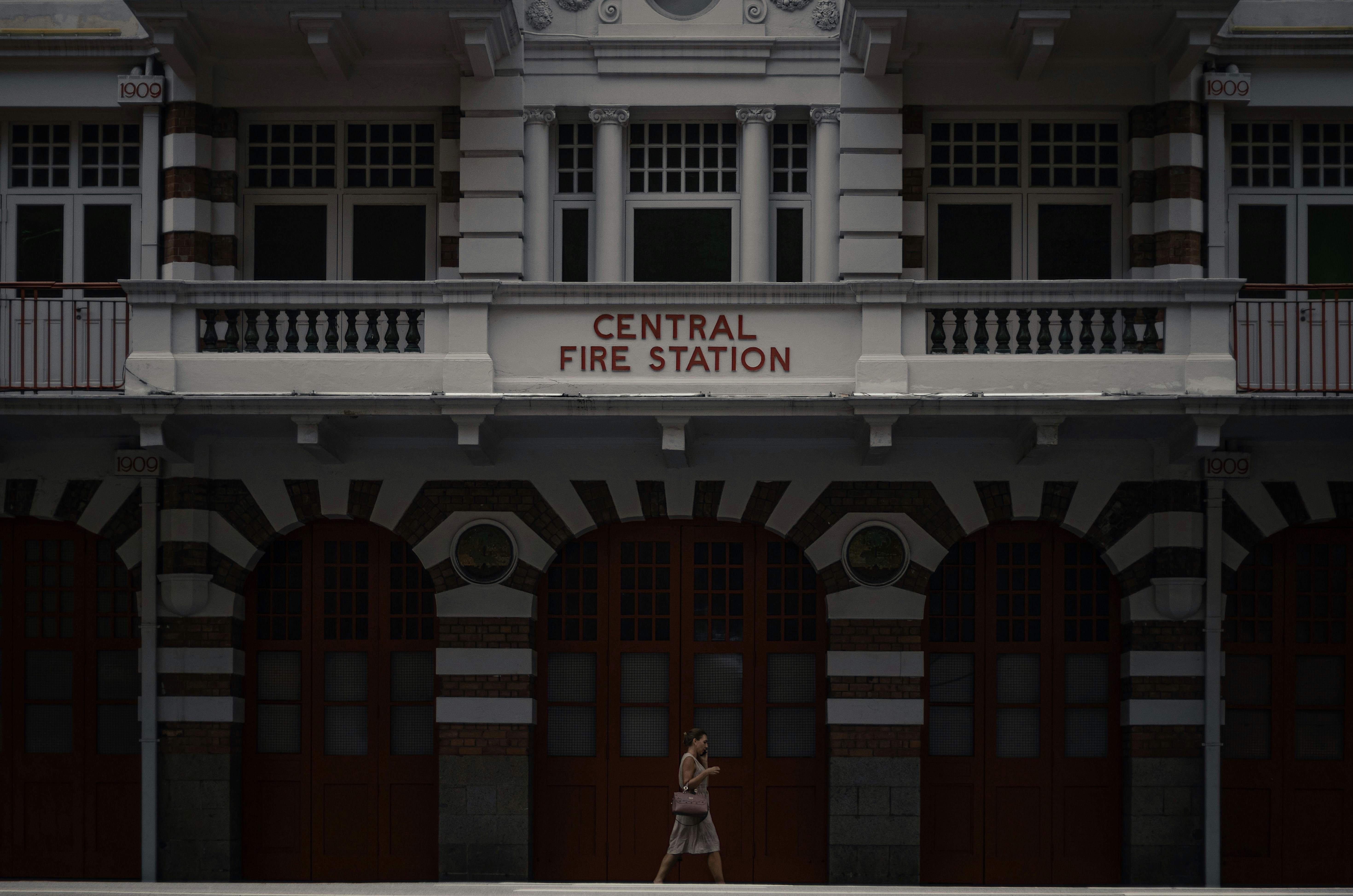 woman in white dress standing in front of white concrete building