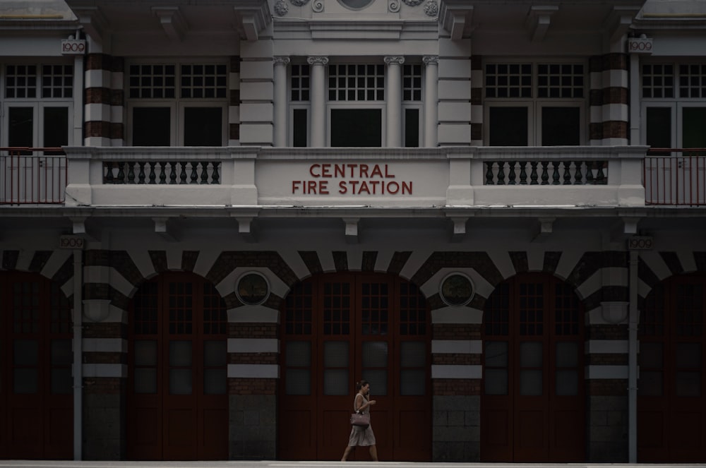 woman in white dress standing in front of white concrete building