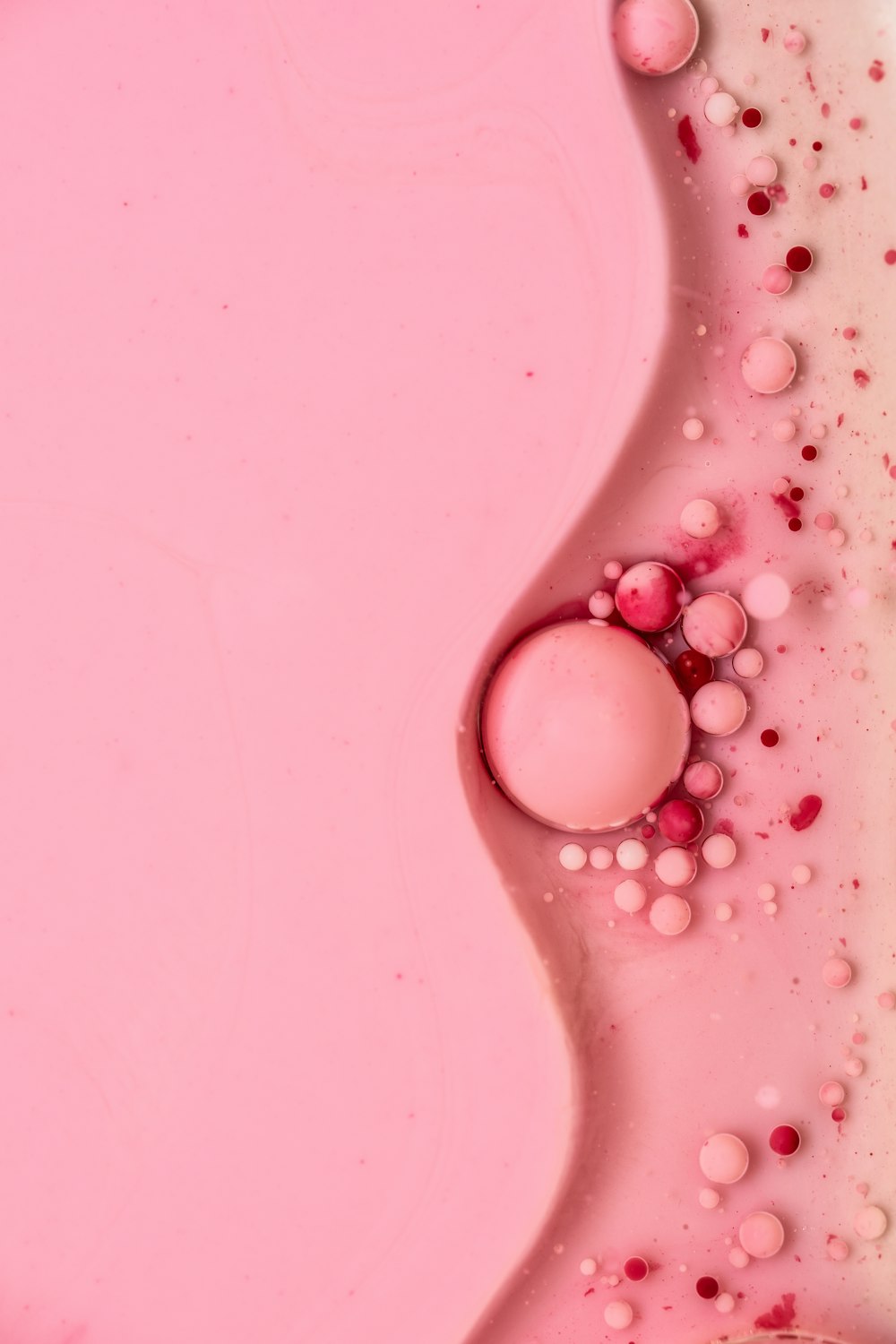 white round beads on pink surface