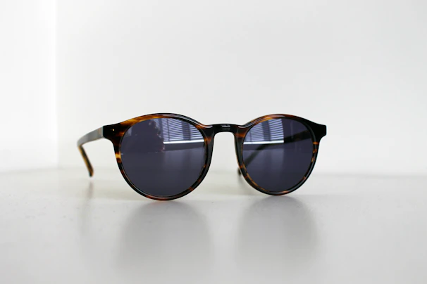 Classic round lenses with tortoiseshell frames illuminated by soft natural light