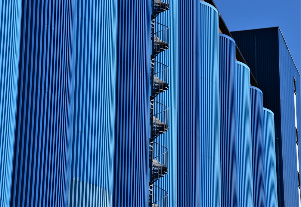 blue and black glass walled high rise building