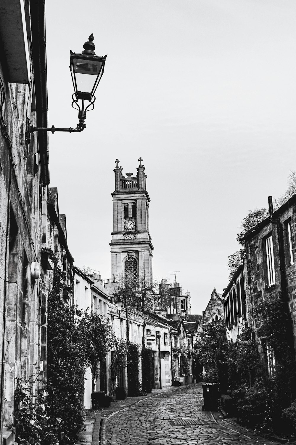 grayscale photo of street light near building