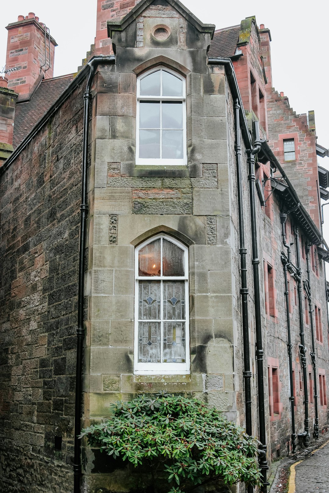 brown brick building with white window