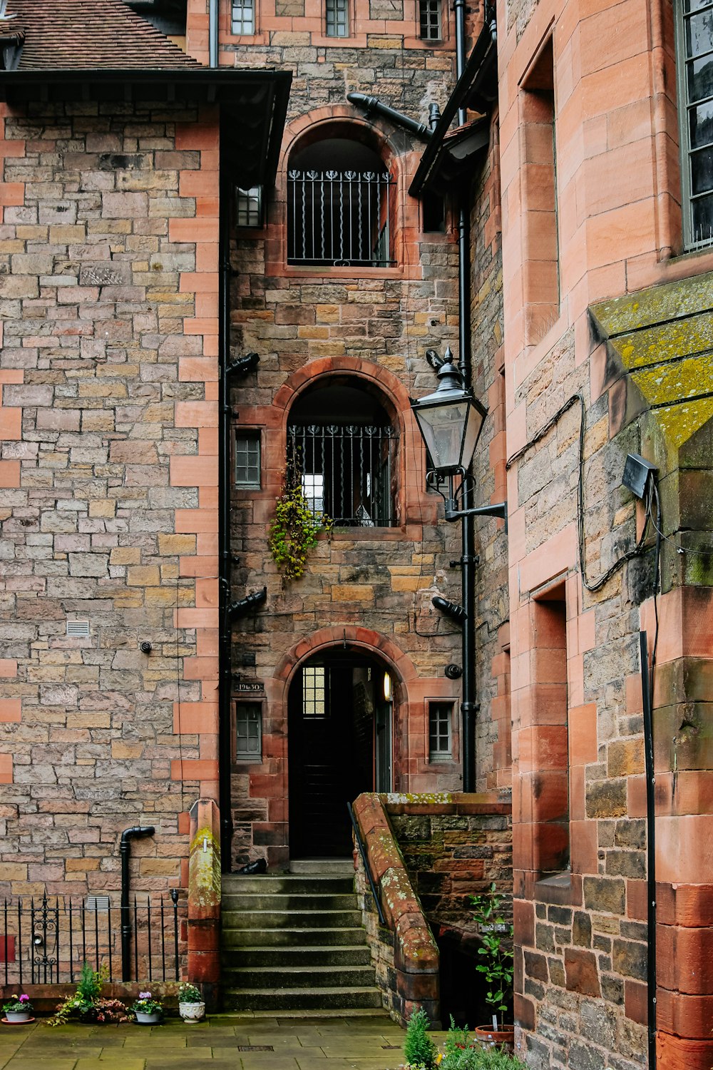 brown brick building with brown wooden bench