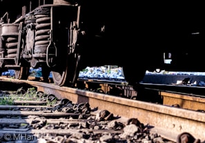 A close-up of a high-speed train wheel on a railway track.