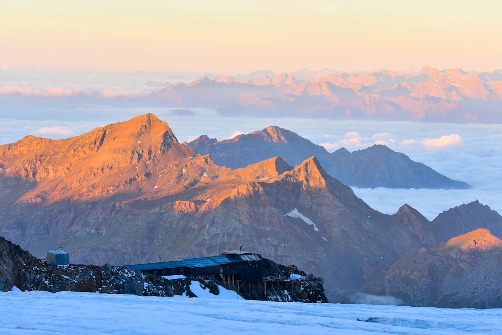 brown and white mountains under white clouds during daytime