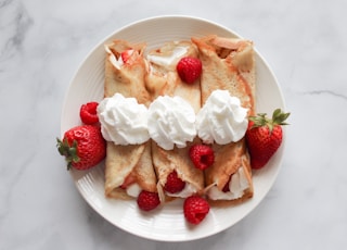 strawberry and banana on white ceramic plate