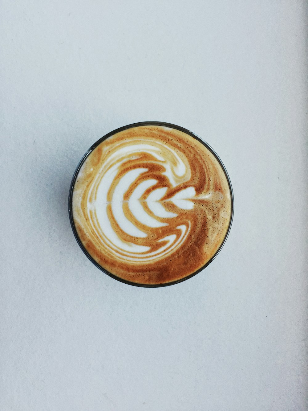 white ceramic cup with brown liquid