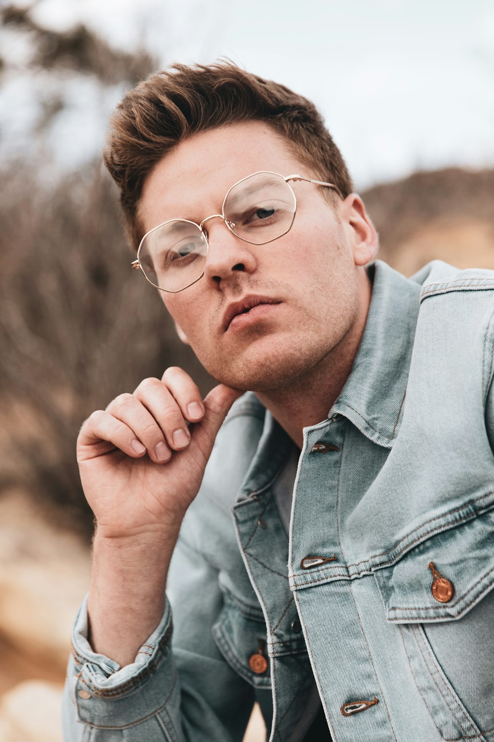 man in blue denim button up shirt wearing eyeglasses