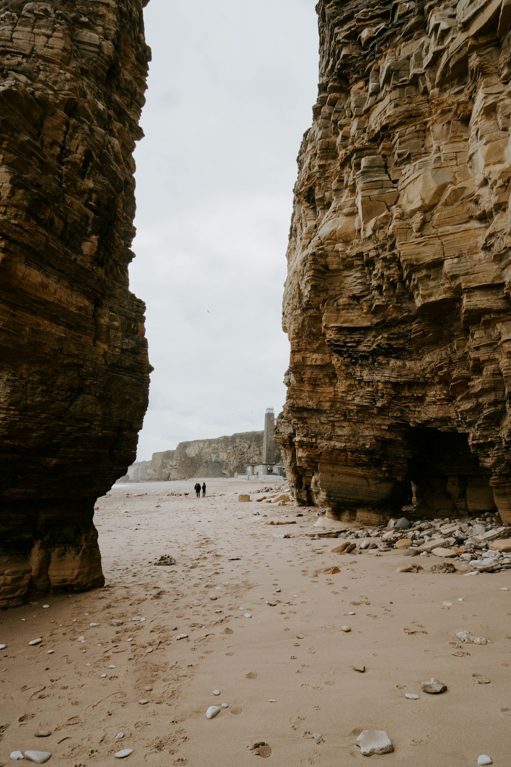 brown rock formation on white sand during daytime