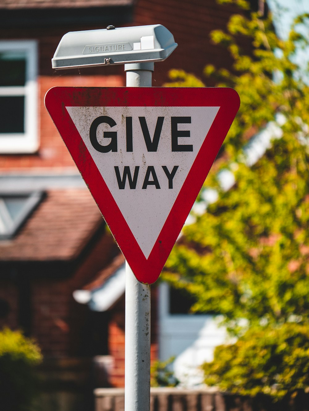 a give way sign in front of a house