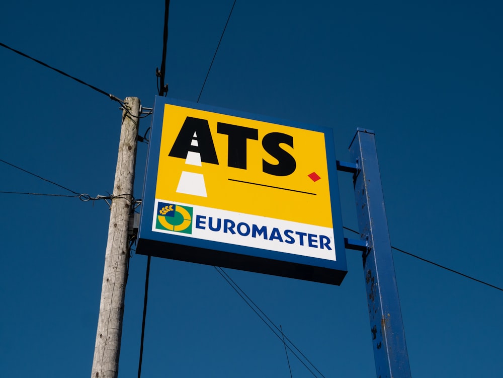 a sign for a gas station with a blue sky in the background