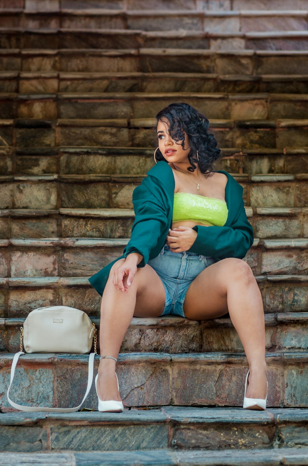 a woman is sitting on a stone step