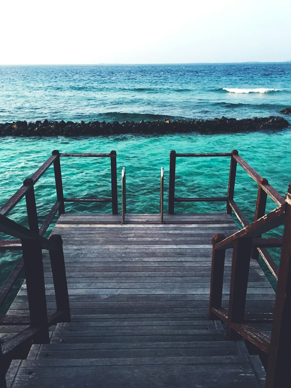 brown wooden dock on sea during daytime