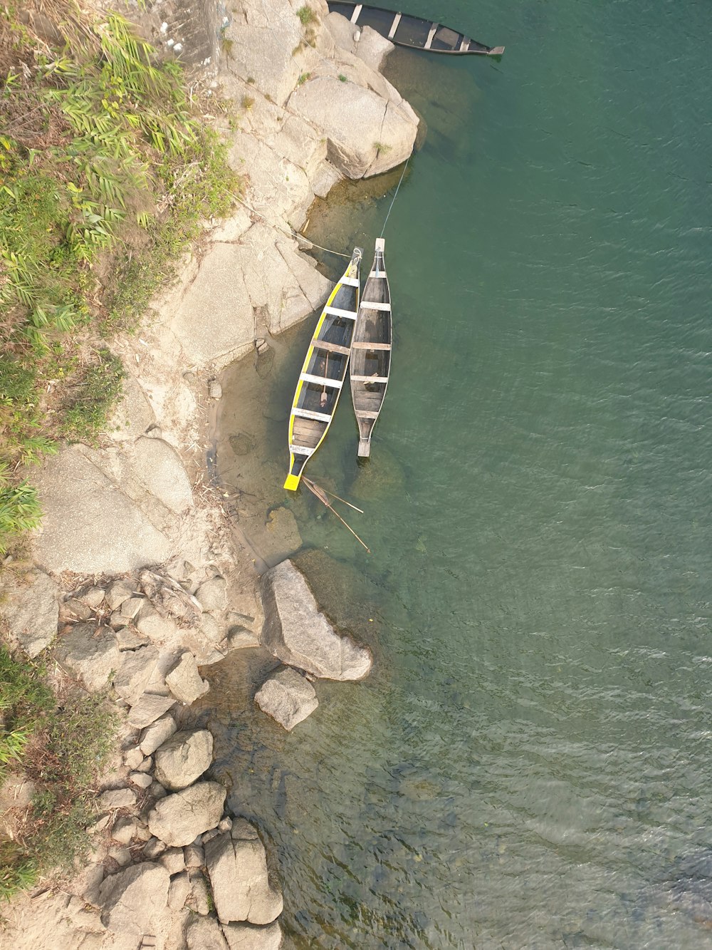 white and black wooden boat on body of water during daytime