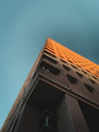 brown concrete building under blue sky during daytime