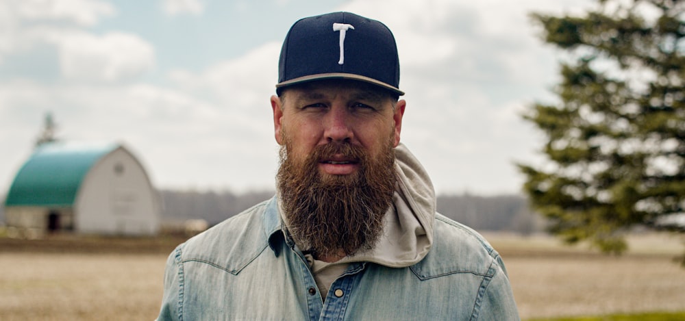 a man with a long beard wearing a hat