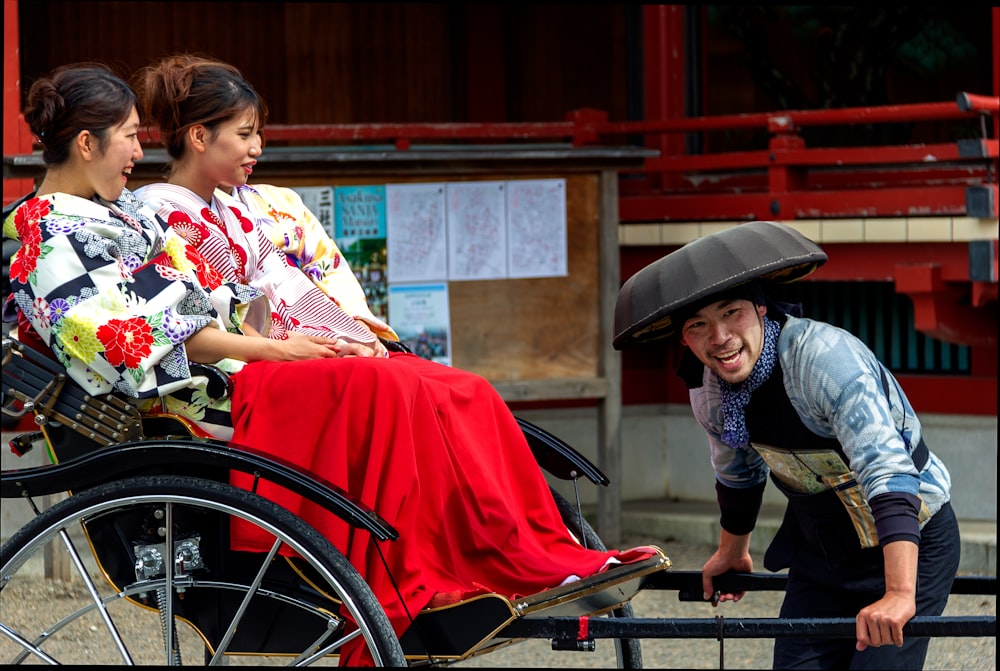 boy in red and white shirt sitting on red and black wheel chair