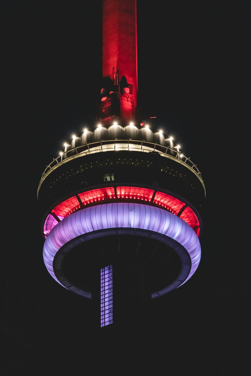 red and black tower with lights during night time
