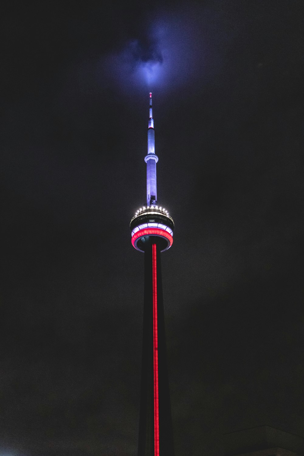 white and red tower during night time