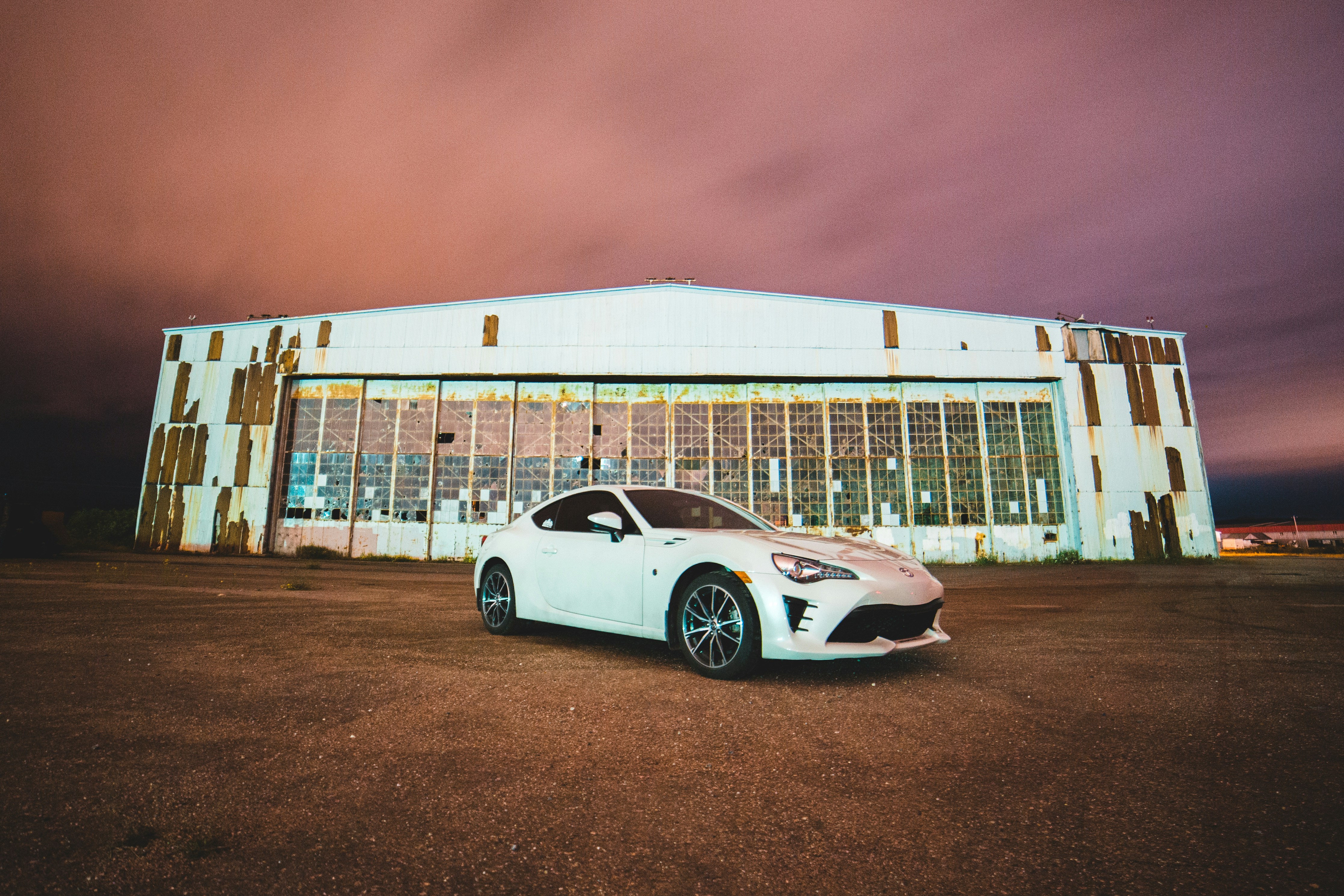 white porsche 911 parked near white building