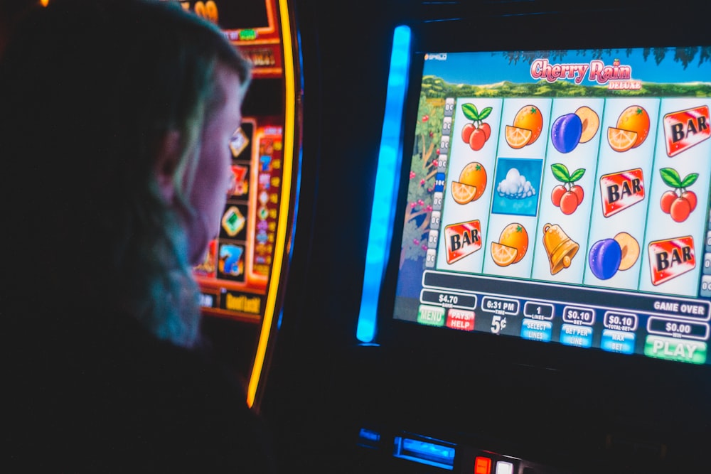 man playing slot machine game photo – Free Human Image on Unsplash