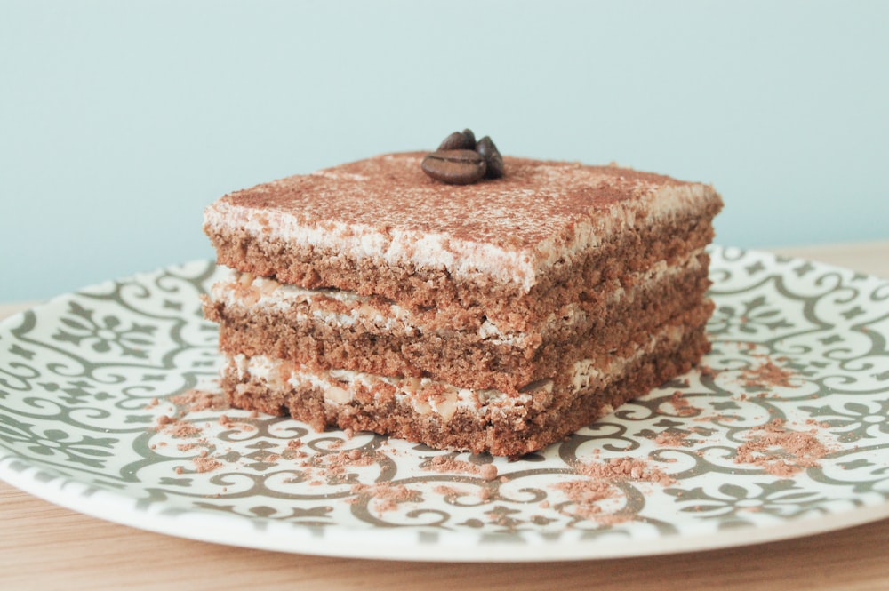 brown cake on white and red floral ceramic plate