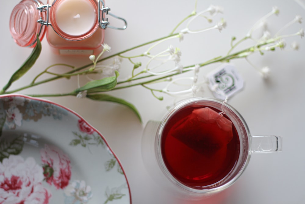 red candle on clear glass holder