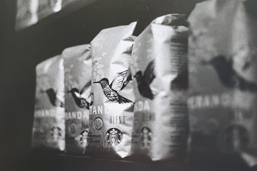 Rows of sleek, custom-designed coffee bags lined up on a conveyor belt ready for shipment.
