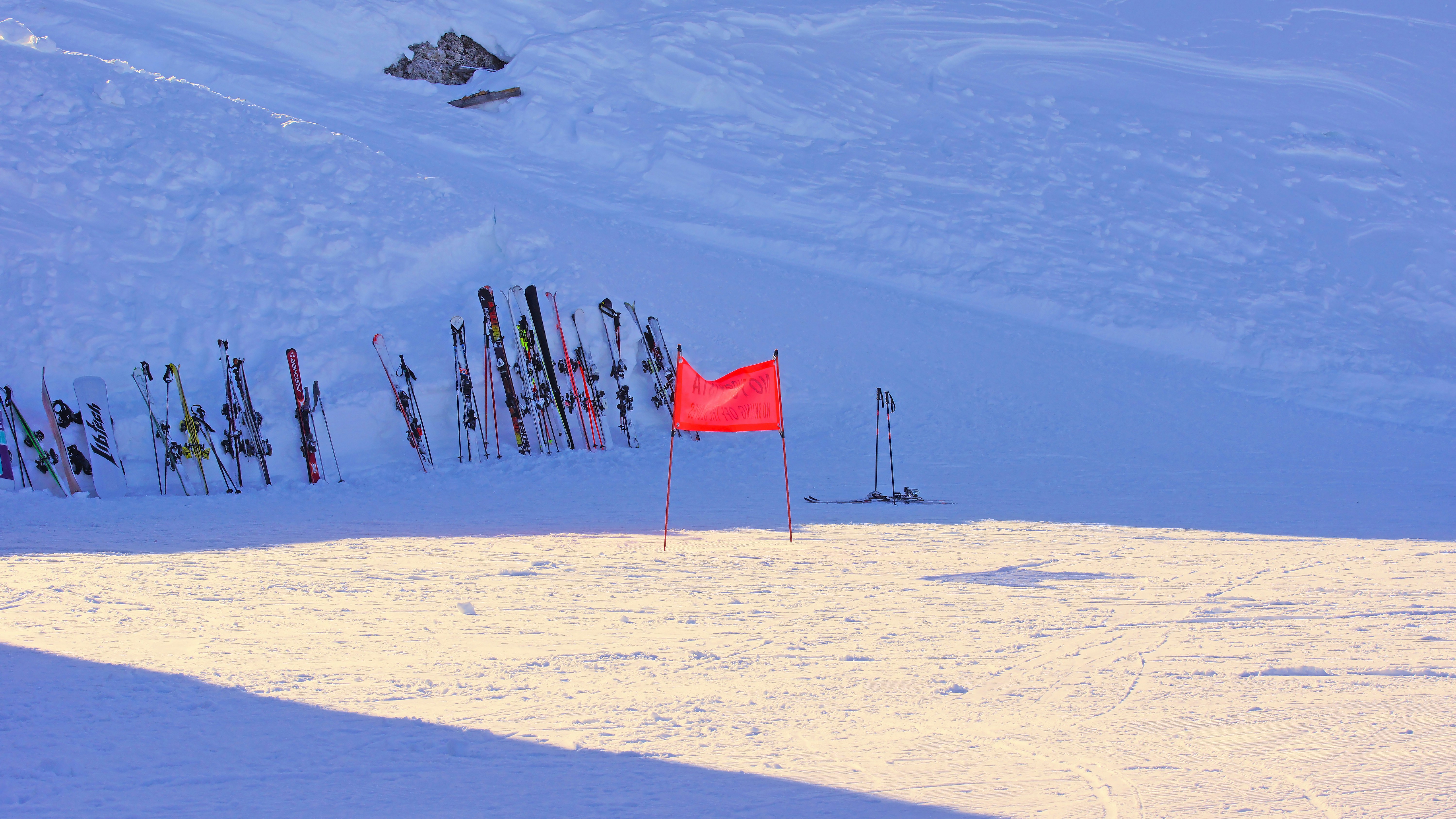 red flag on white snow covered mountain during daytime, 
