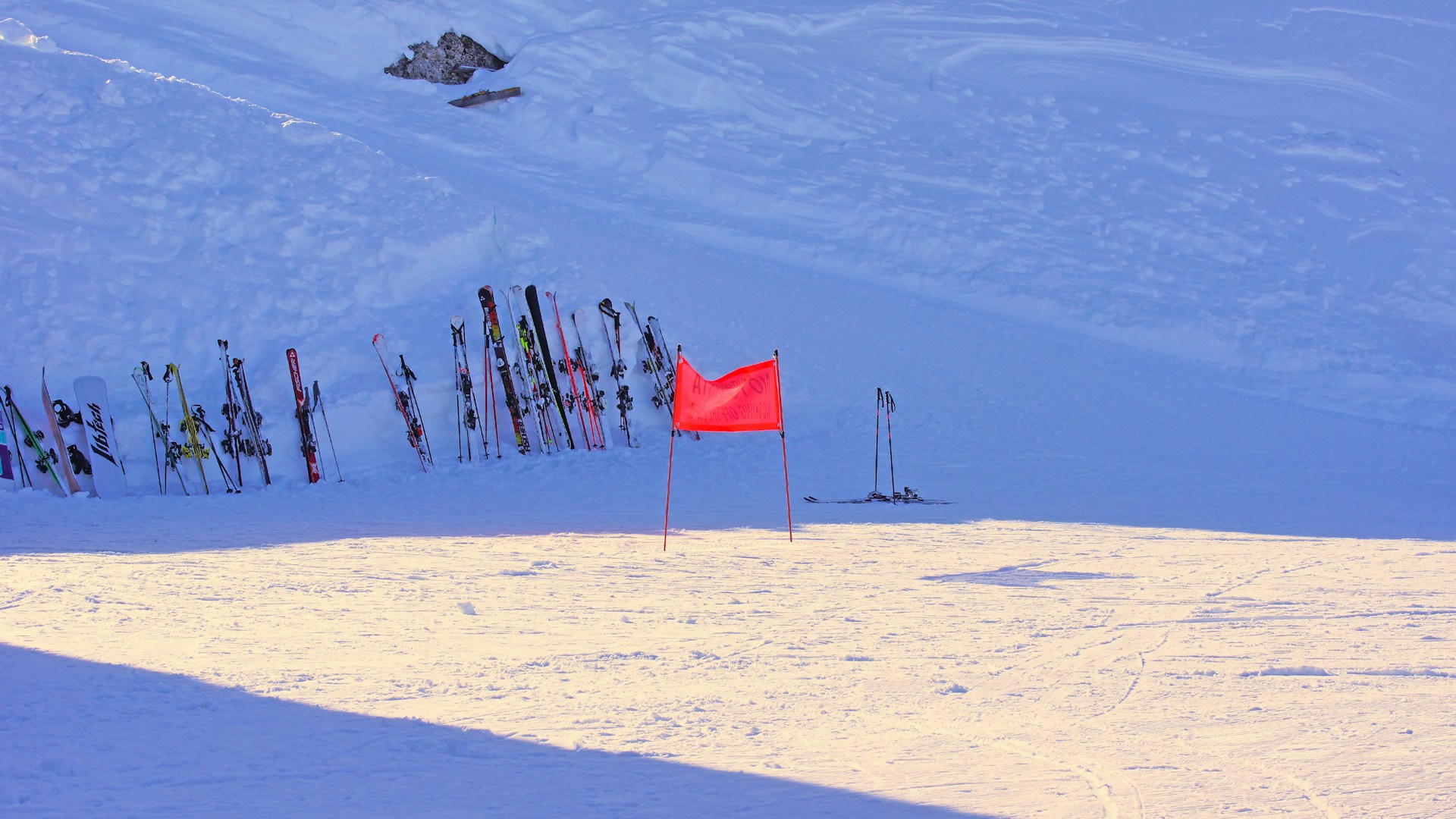 red flag on white snow covered mountain during daytime