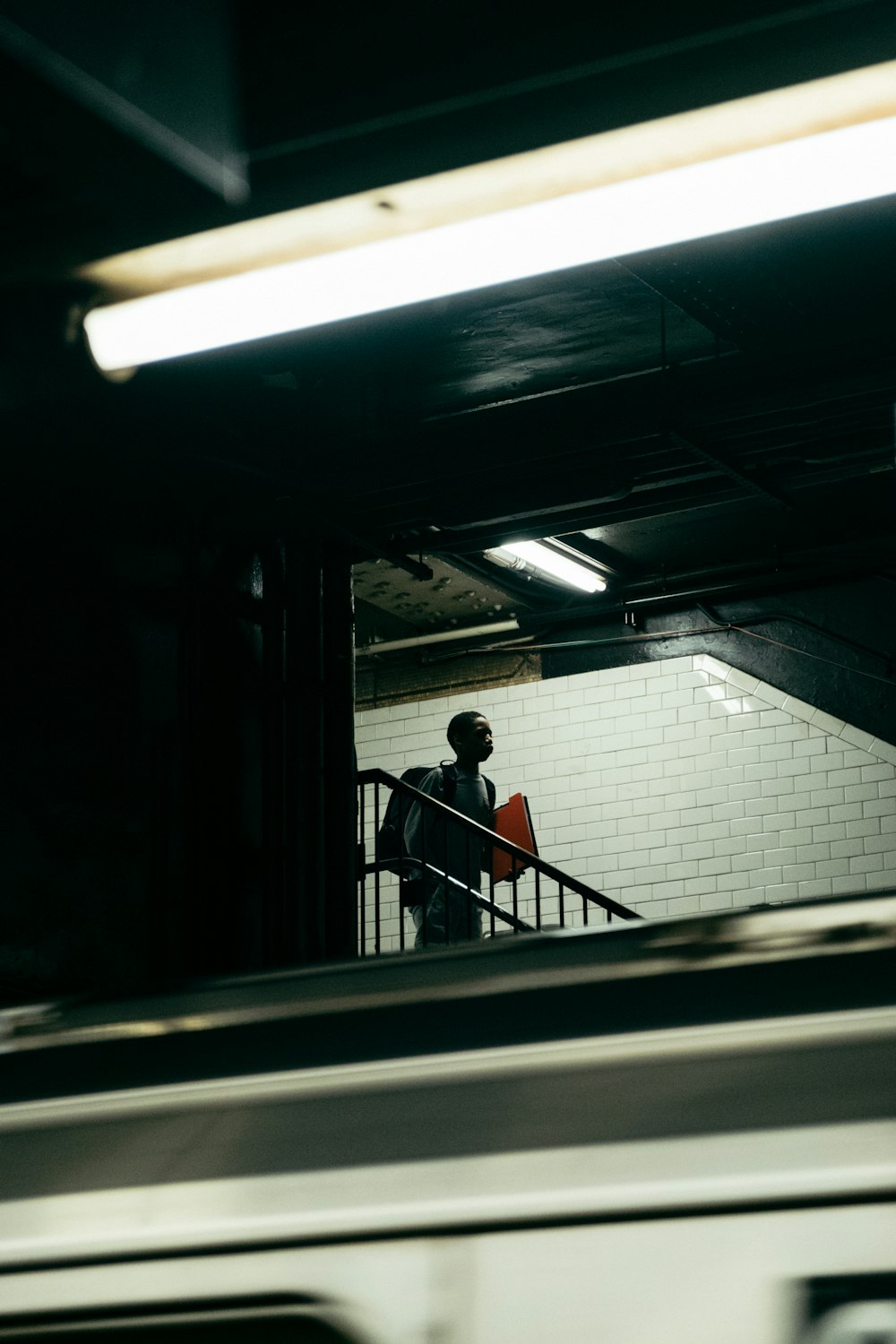 man in black shirt sitting on train station