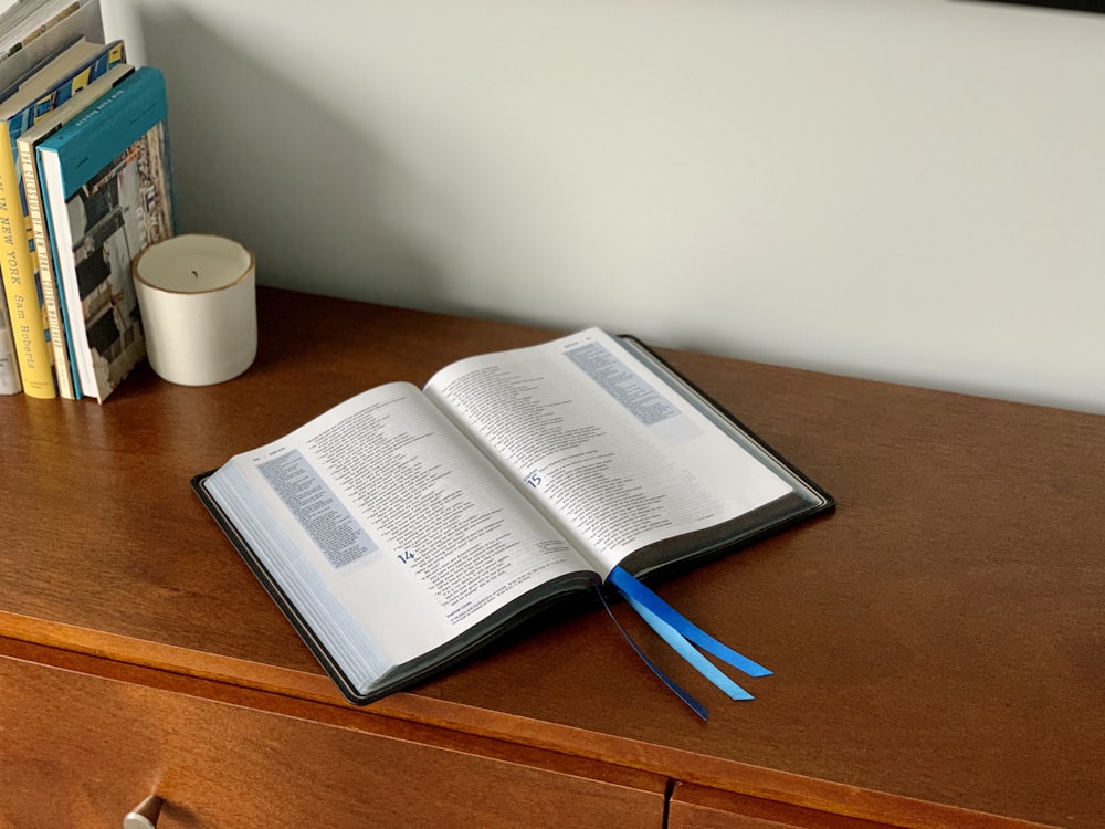 an open book sitting on top of a wooden desk