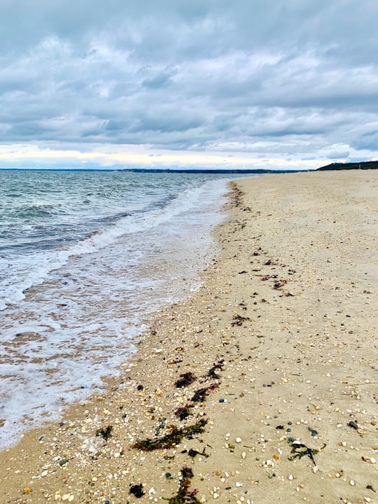 sea waves crashing on shore under blue and white cloudy sky during daytime in Sunken Meadow State Park United States