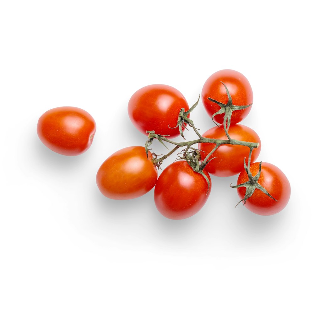 red tomatoes on white surface