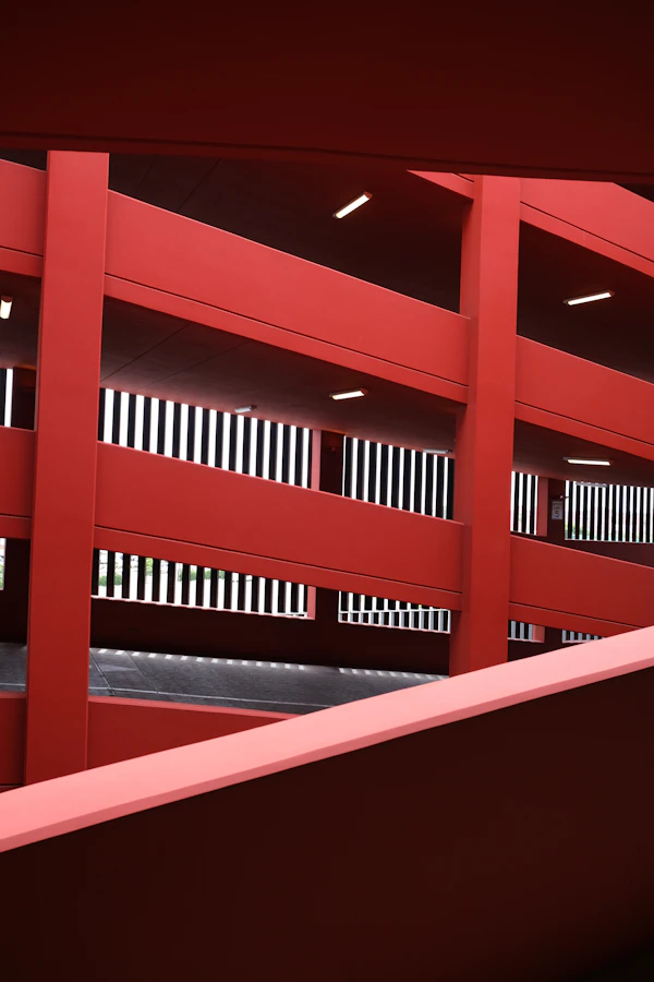 A red car park structure with white railings
